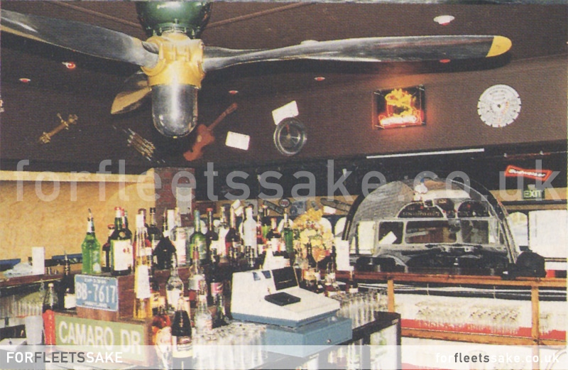 THE BAR AREA INSIDE DAKOTAS 1992. Behind the bar at Dakota's, showing the cockpit at the front of the restaurant and the propellor ceiling fan. History of Fleet Hampshire.